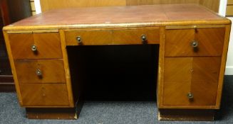 A large vintage office desk having two banks of three drawers and a single centre drawer all below a