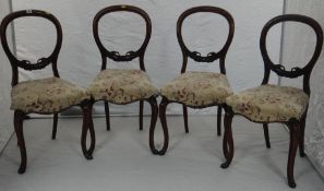 A set of four mahogany balloon-back chairs with cushion-seats