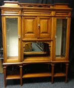 An Edwardian mahogany sideboard, the centre breakfront having a latticed effect back rail and the