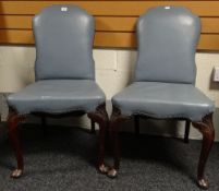 A pair of blue upholstered Georgian style library chairs