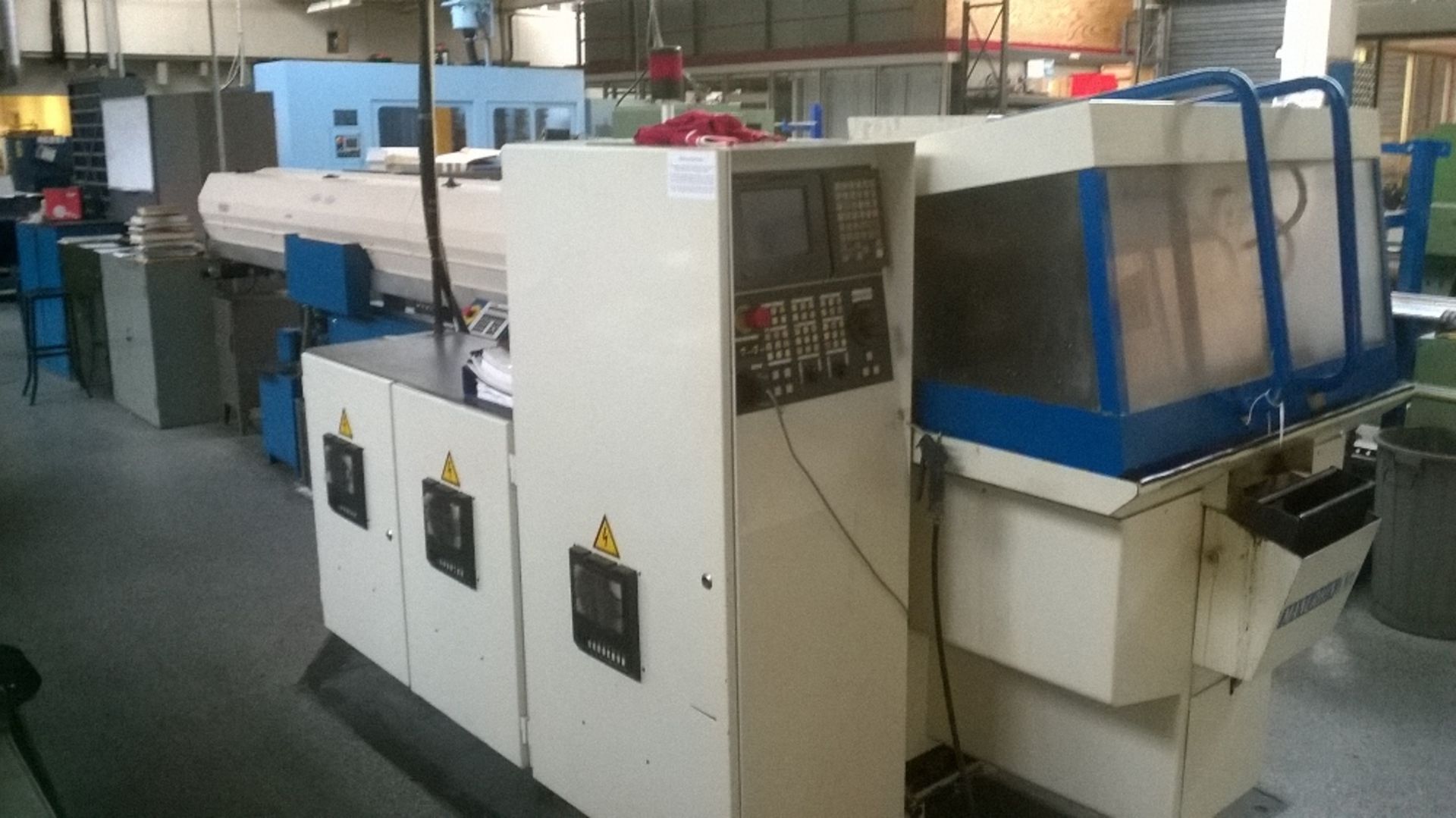 Manurhin KMX model 326 sliding head auto CNC turning center (6 driven tools, 6 fixed tools) Serial