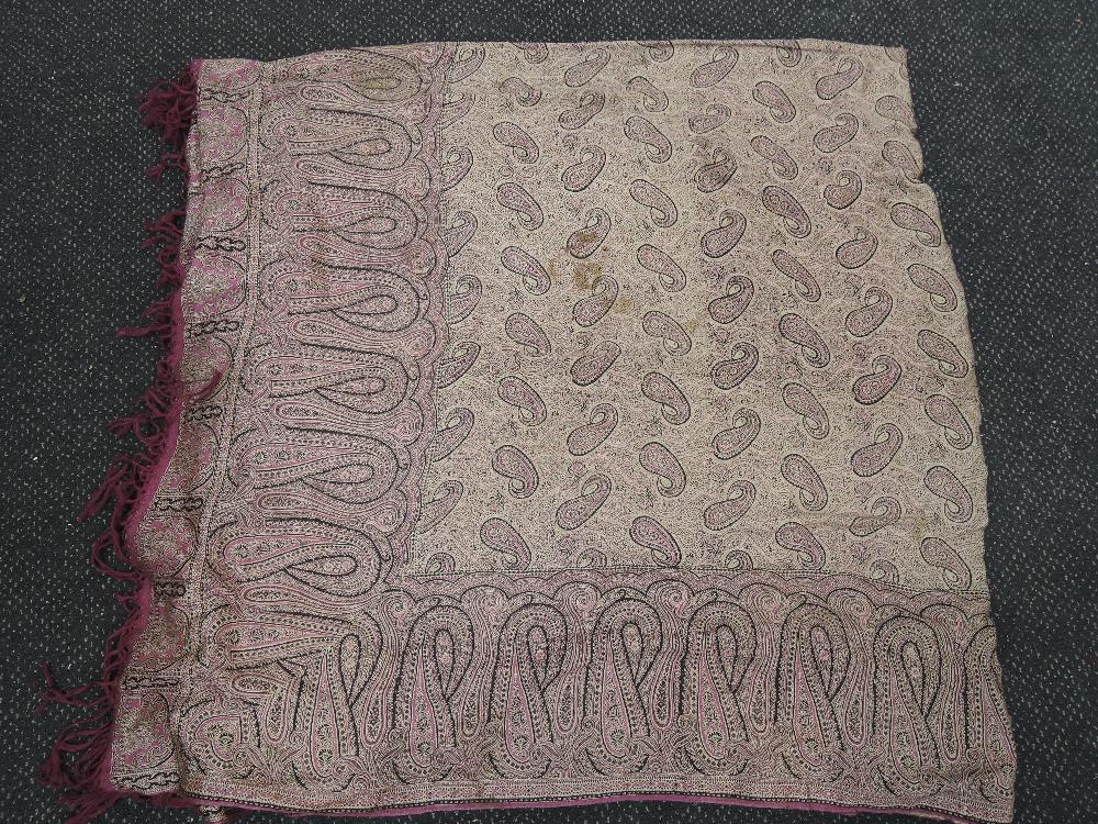 A traditional throw having purple and black Paisley design