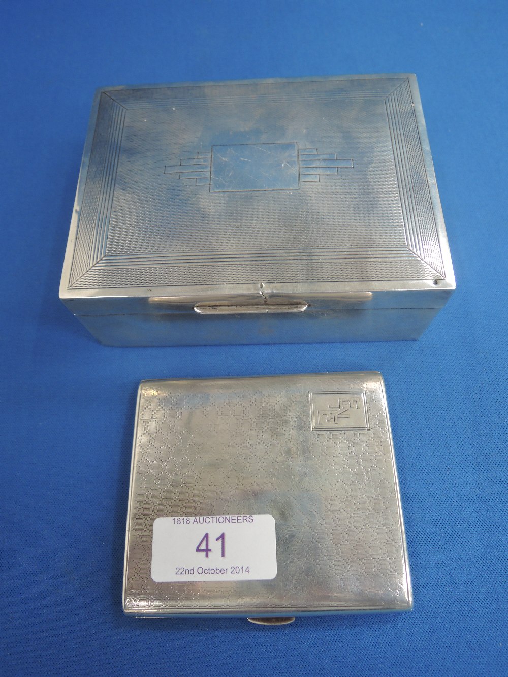 A hallmarked silver cigarette case and a white metal cigarette box, stamped silver