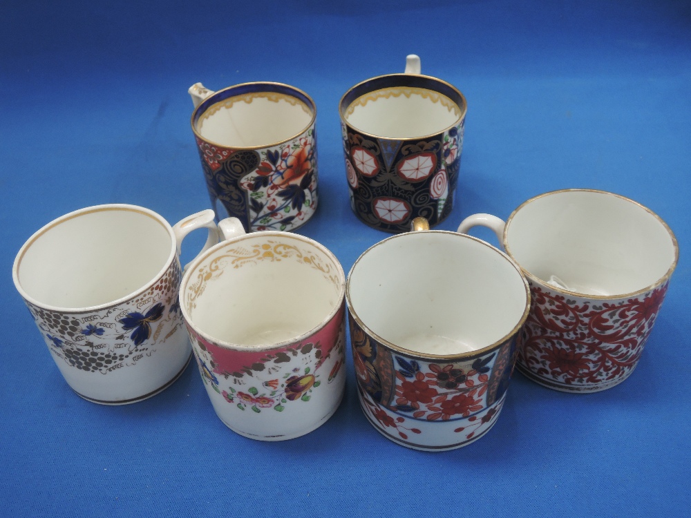 A 19th century Derby cup in the Imari palette, a similar cup and four other 19th century cups