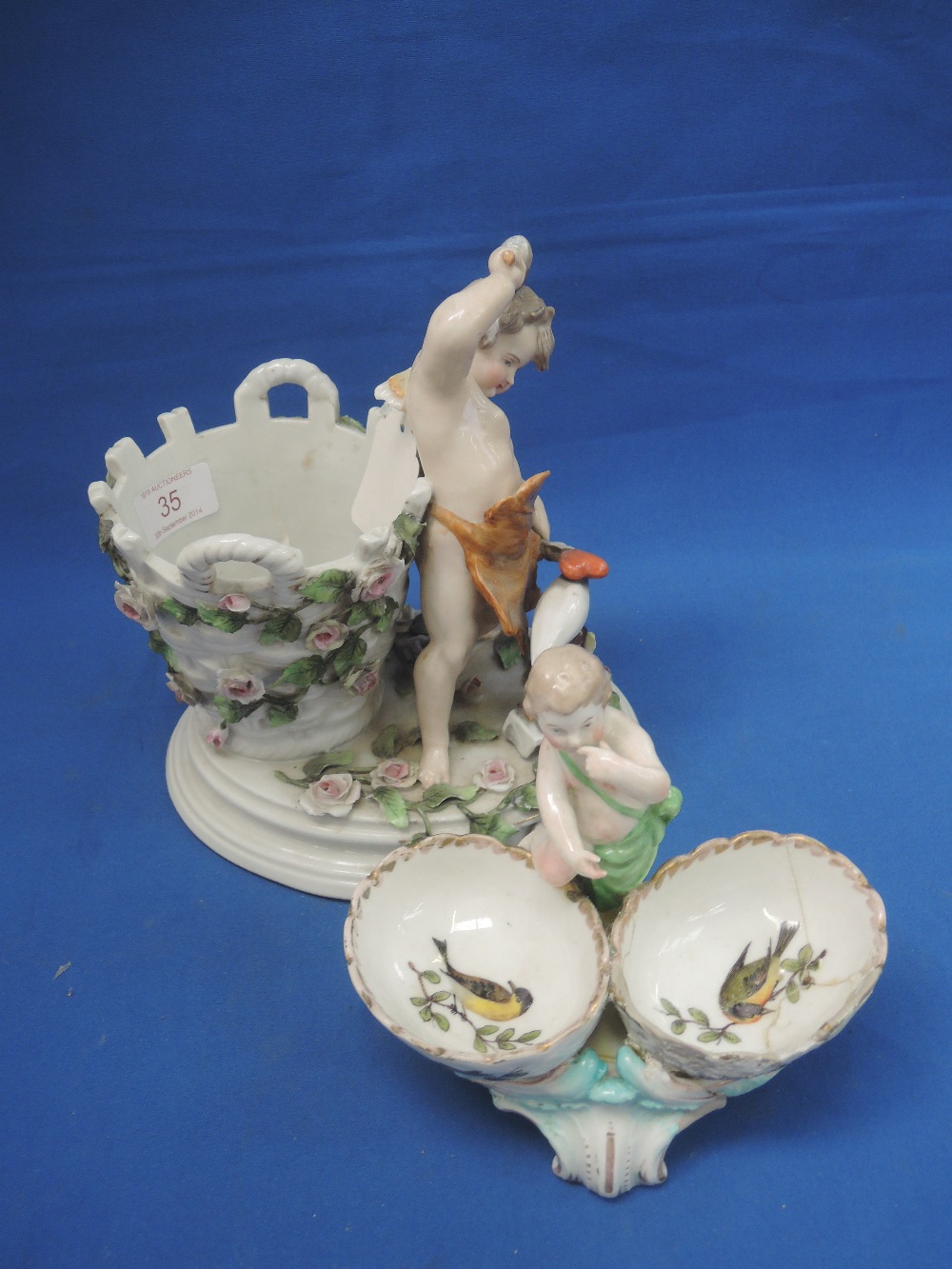A 19th century Meissen style figure/group/vase modelled as angelic cherub putti forging his heart,