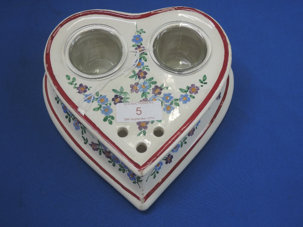 An early 20th century Wemyss ink stand of romantic heart shape, inset with glass pots and painted