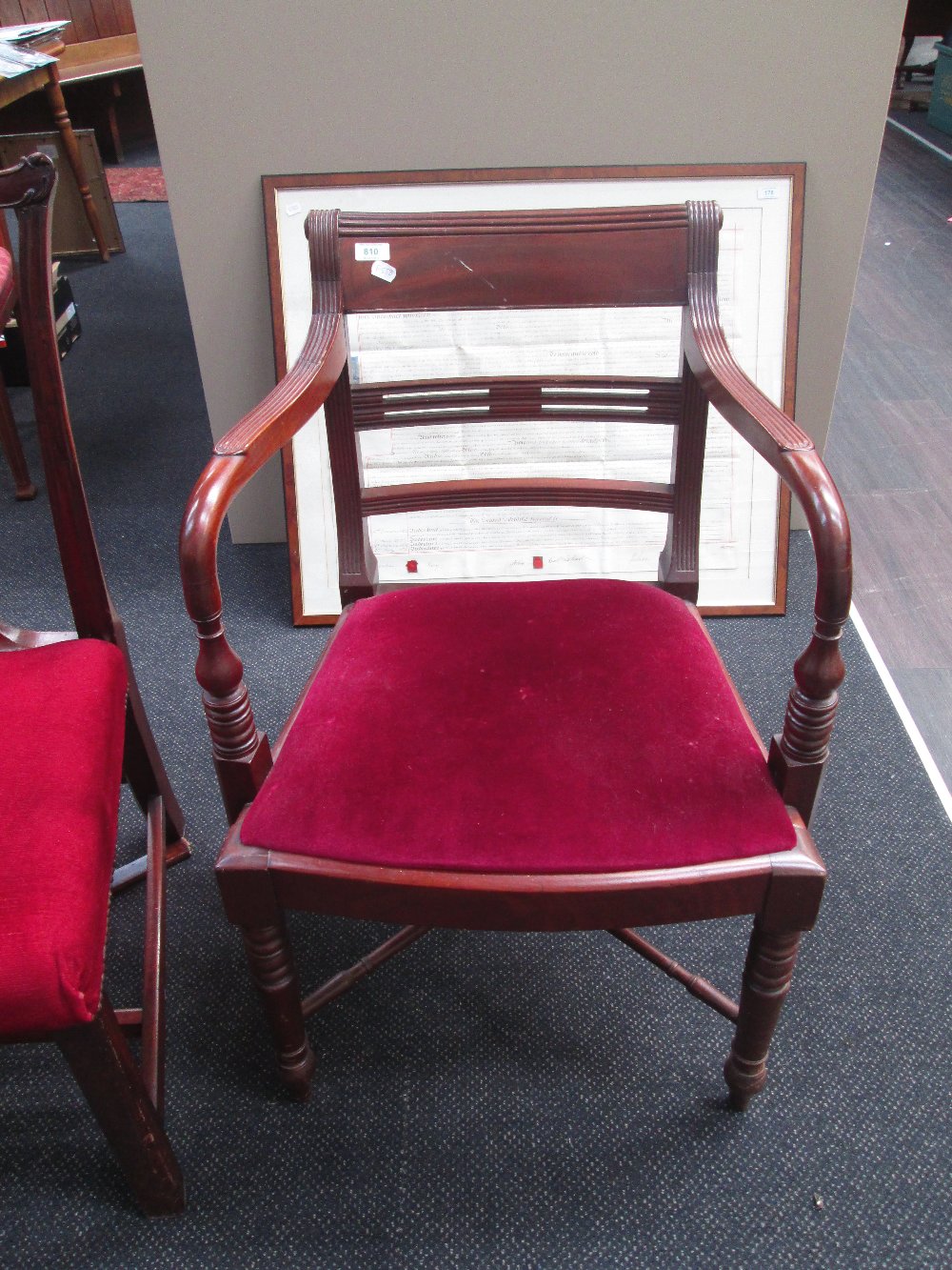 A 19th century mahogany carver chair in The Regency design having rail back, later seat and ring