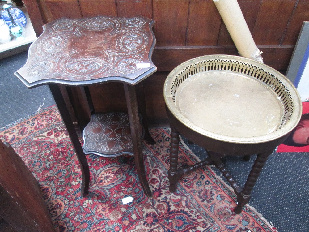 An early 20th century stained frame occasional table having incised decoration and a similar period