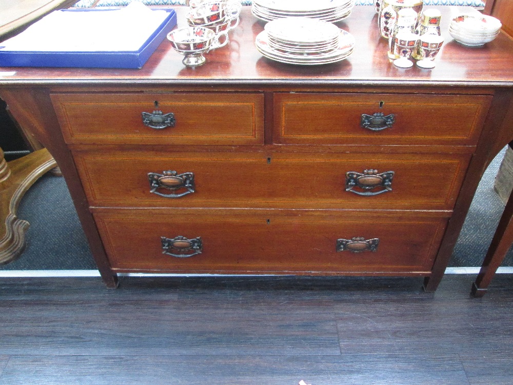 An Edwardian mahogany dressing chest, having two short and two long drawers, oversized top, with