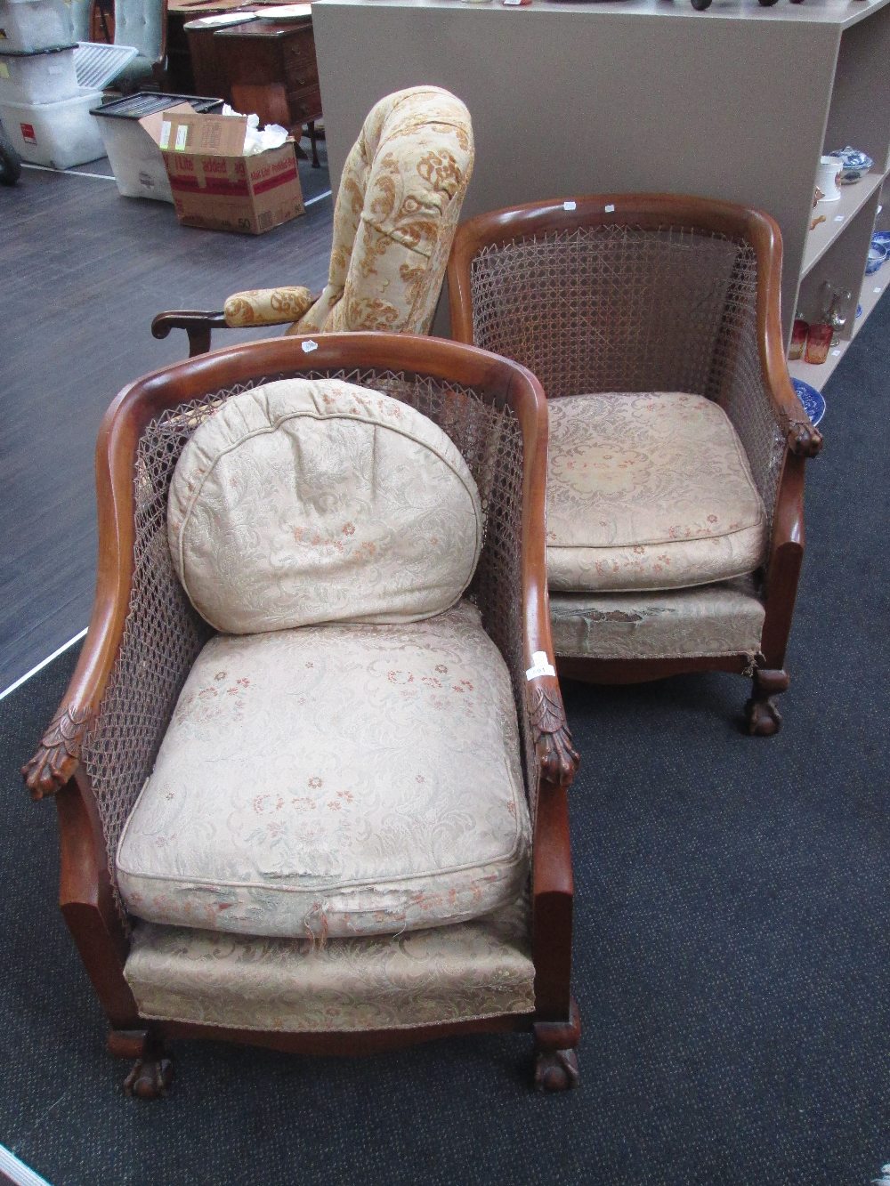 A pair of early 20th century stained frame armchairs having bergere cane panel, and animalistic