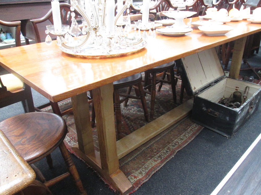 A mid 20th century golden oak refectory table having square legs
