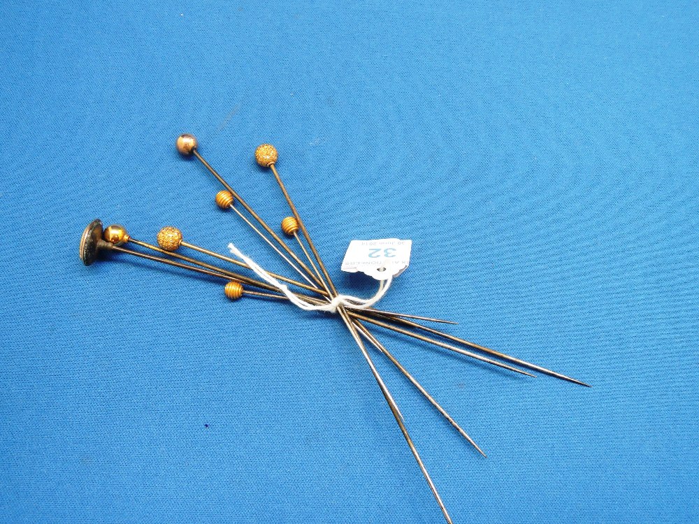 Eight yellow metal short hatpins including 9ct gold spherical form