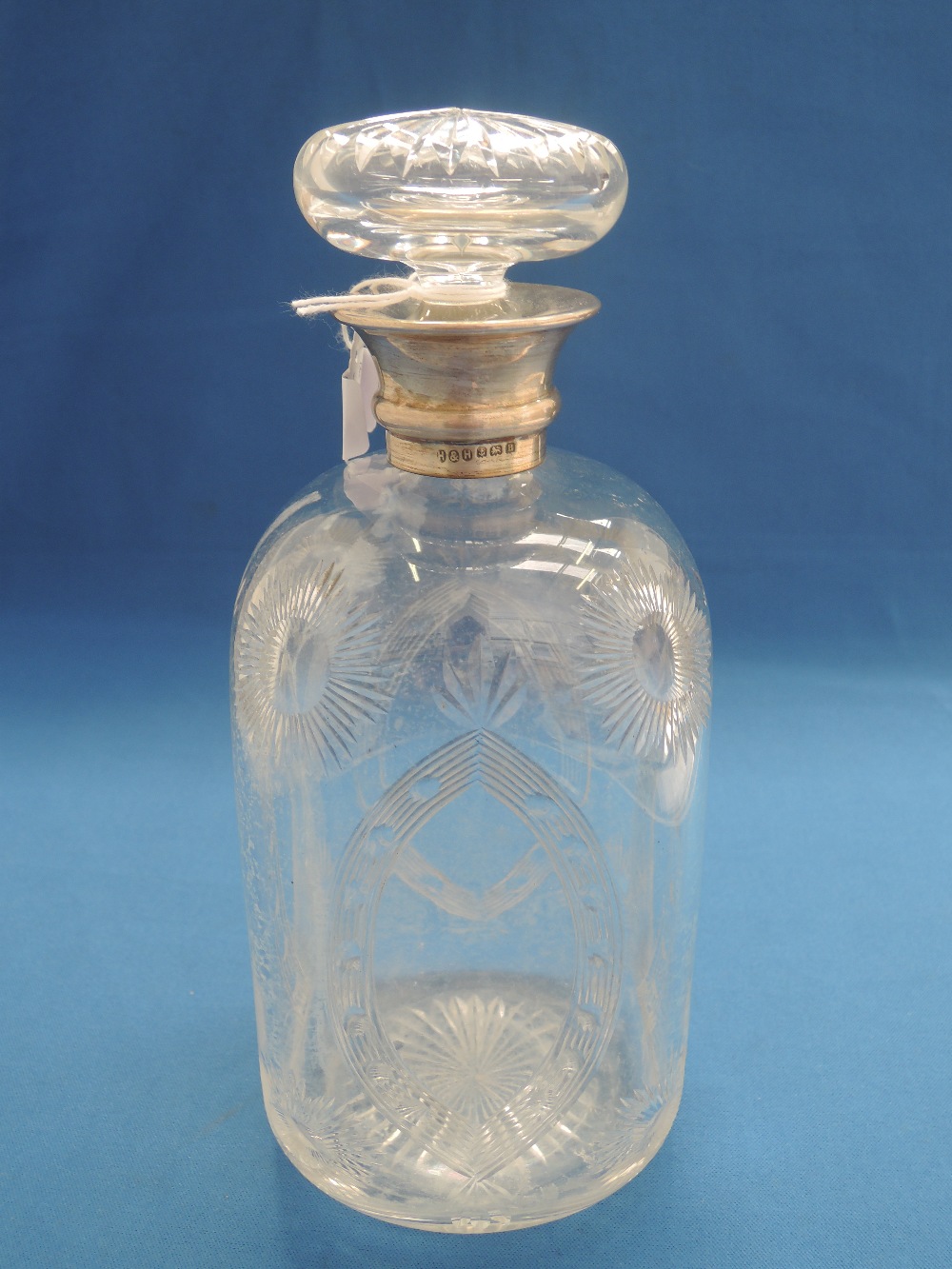 A cut glass decanter having sun burst and shield decoration with a silver collar, Birmingham 1926,