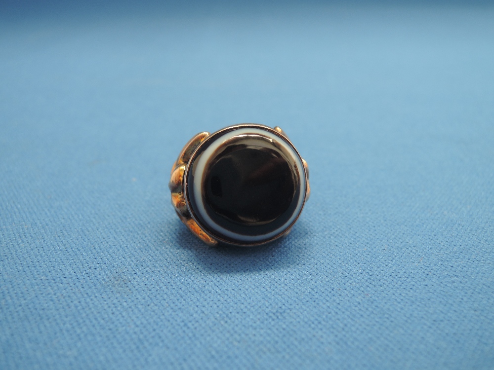 A dress ring having large blood red ringed agate style stone on a collarette mount having