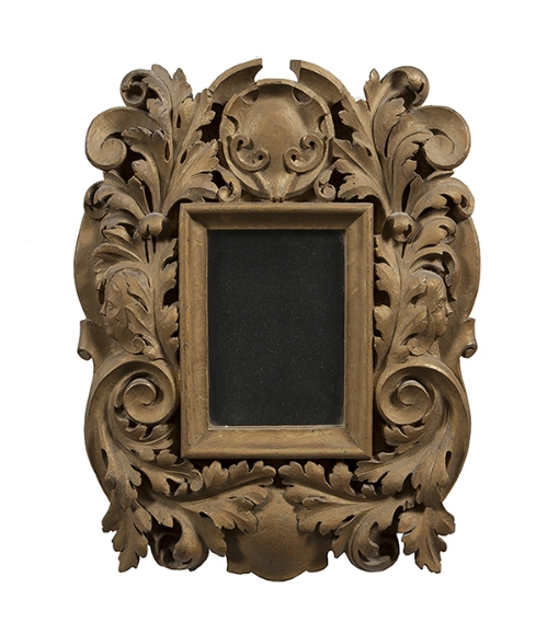 A CARVED GILTWOOD WALL MIRROR, the rectangular plate within a frame profusely carved with leaf