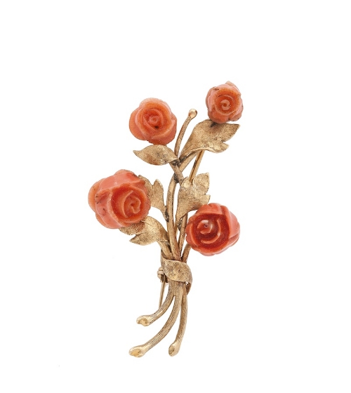 A coral brooch, the floral spray set throughout with carved coral flowers, length 5cm together