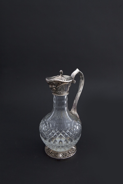A CUT GLASS AND SILVER MOUNTED CLARET JUG, Birmingham 1911-12, of ovoid form, with lift top above