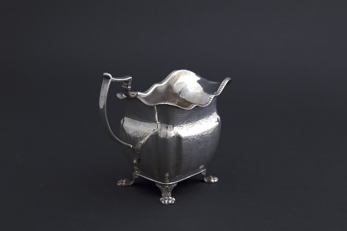 AN IRISH GEORGE III BRIGHT CUT ENGRAVED SILVER CREAM JUG, Dublin 1816, mark of James le Bas, with