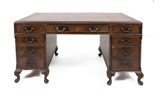 A MAHOGANY CROSSBANDED AND LEATHER INSET PARTNERS DESK, in Georgian style, the rectangular top