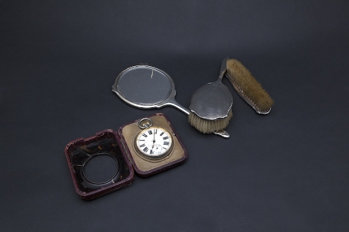 A THREE PIECE SILVER DRESSING TABLE SET, marks rubbed), comprising a hand mirror, hair brush,