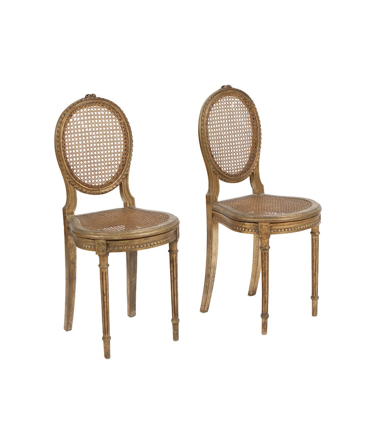 A PAIR OF FRENCH LOUIS SEIZE STYLE GILTWOOD SALON CHAIRS, the caned oval panel backs and seats on