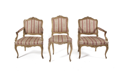 A PAIR OF 19TH CENTURY CARVED GILTWOOD FRAMED ARMCHAIRS, and a matching side-chair, the arched panel