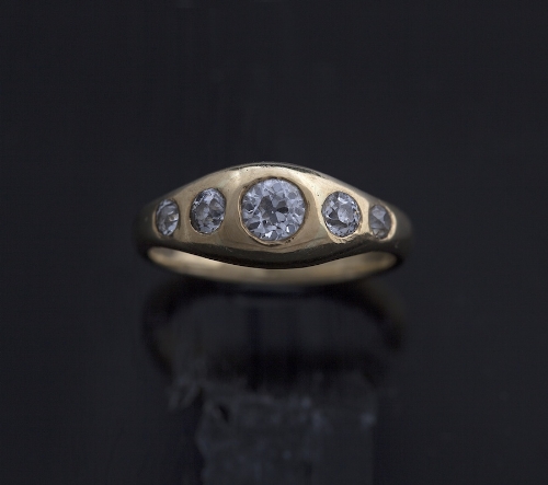 A diamond five stone ring, composed of graduated round brilliant-cut diamonds to a tapering 18 carat