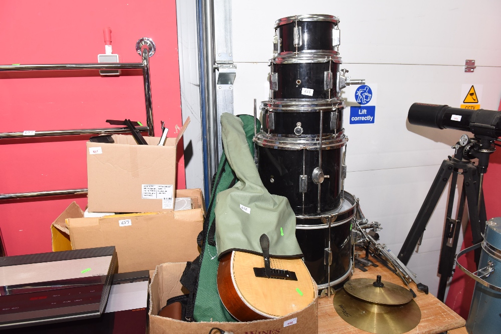 An acoustic guitar tog. with vintage cameras and a Stagg drum kit