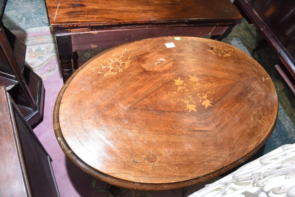 A 19th century inlaid mahogany small loo table on cluster column legs