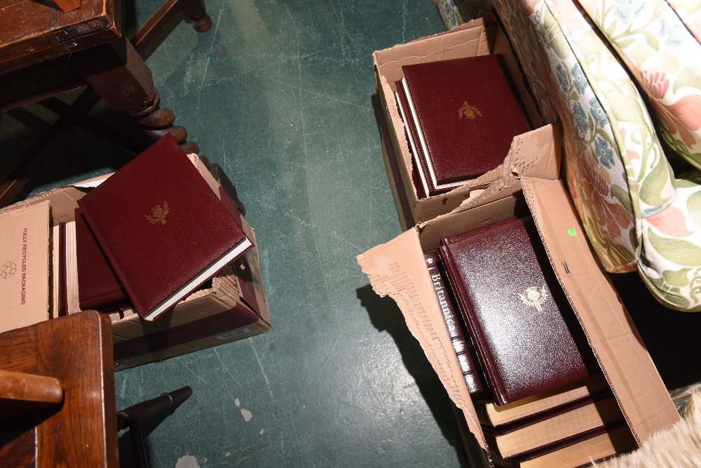 Three boxes containing Encyclopedia Britannica, thirty two volumes