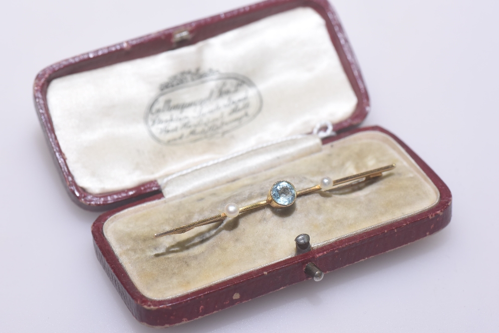 A 9ct gold aquamarine and seed pearl bar brooch, in the Edwardian taste, cased.