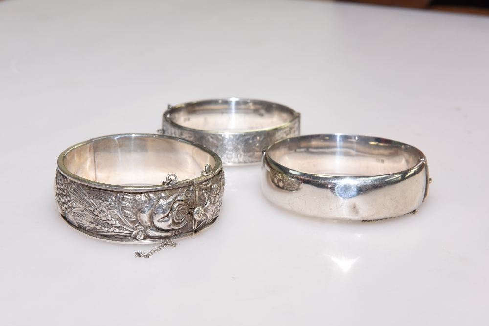 Three vintage silver bangles, two with English hallmarks, one foreign