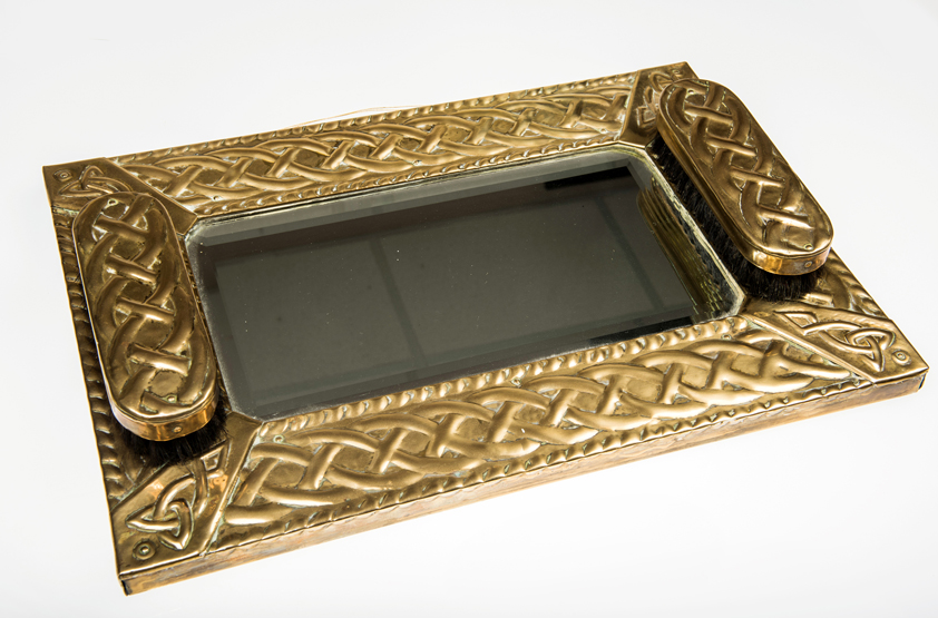 A SCOTTISH ARTS AND CRAFTS BRASS HALL MIRROR, c.1910, the rectangular plate within a conforming