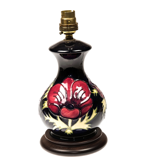 A MOORCROFT POTTERY TABLE LAMP, tubelined and hand painted in the `Anemone` pattern. Height 24cm (