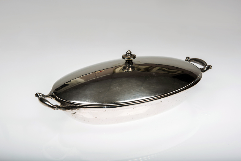 A W.A.S. BENSON SILVER-PLATED SERVING DISH, oval, the cover with urn finial, ceramic lined and the