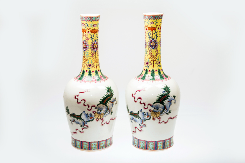 A PAIR OF CHINESE PORCELAIN BOTTLE VASES, painted with dogs of fo and lotus blossoms, each with