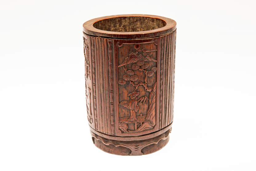 A CHINESE CARVED BAMBOO BRUSH POT, decorated with panels of figures in landscapes divided by