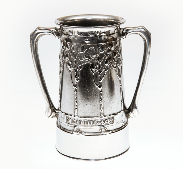 A LIBERTY & CO. PEWTER LOVING CUP, DESIGNED BY ARCHIBALD KNOX, decorated with stylised trees and