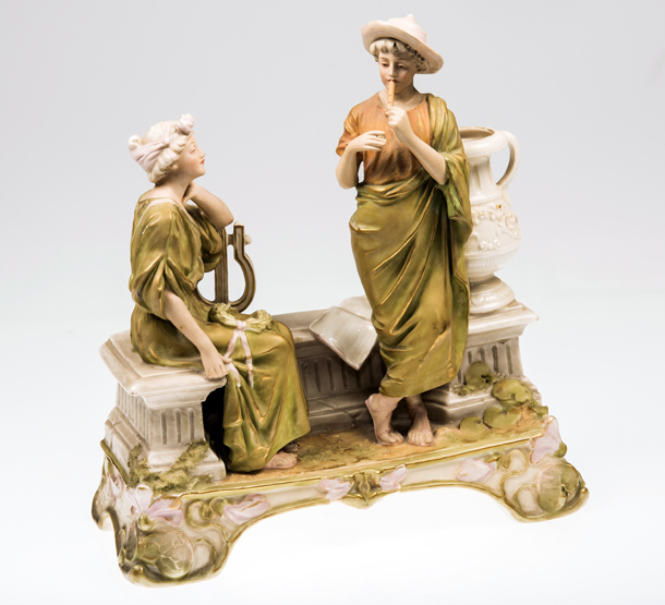 A ROYAL DUX (BOHEMIA) FIGURE GROUP, c. 1900, of a courting couple in Classical dress by a