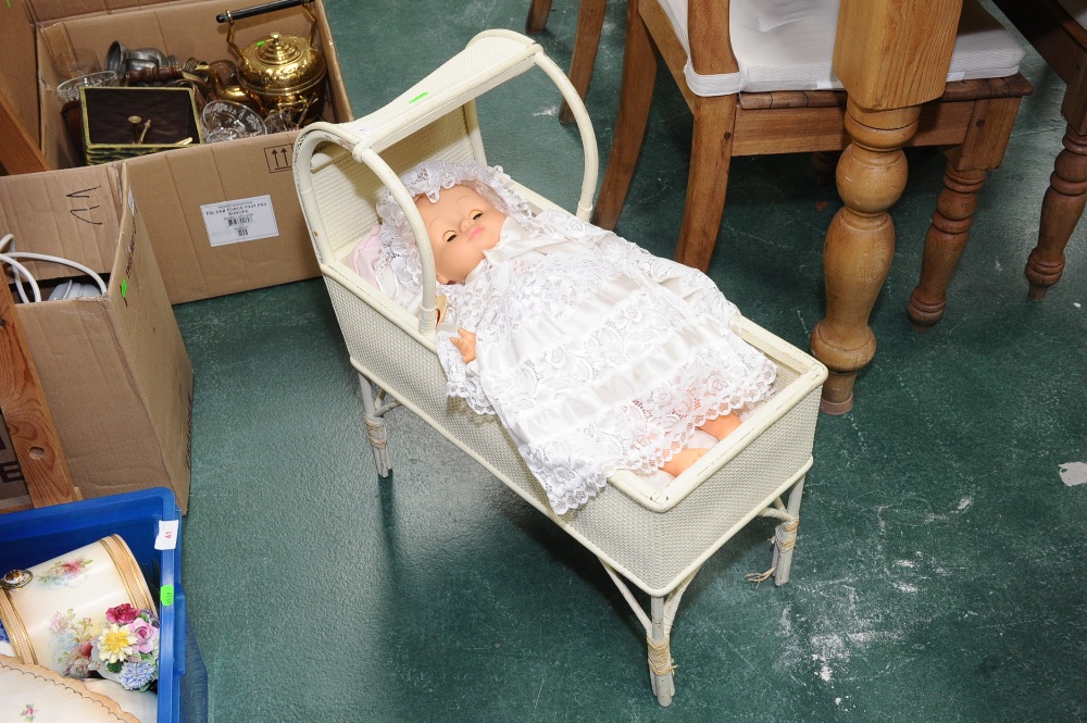 A wicker crib and doll