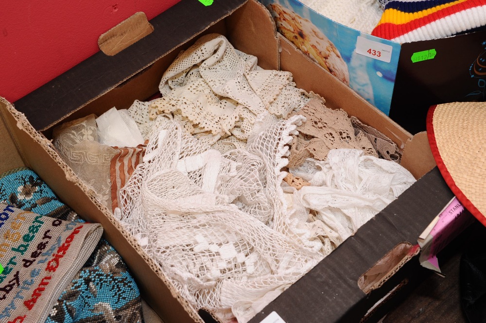 A box containing a quantity of lace fragments