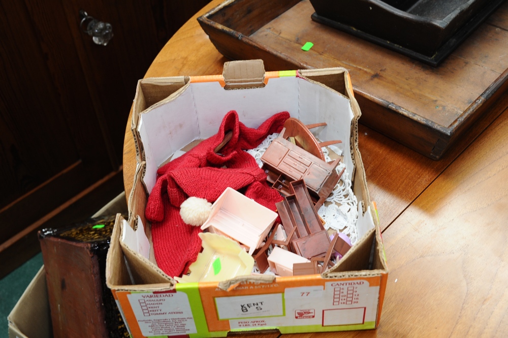 A box containing a quantity of dolls house furniture and dolls clothing