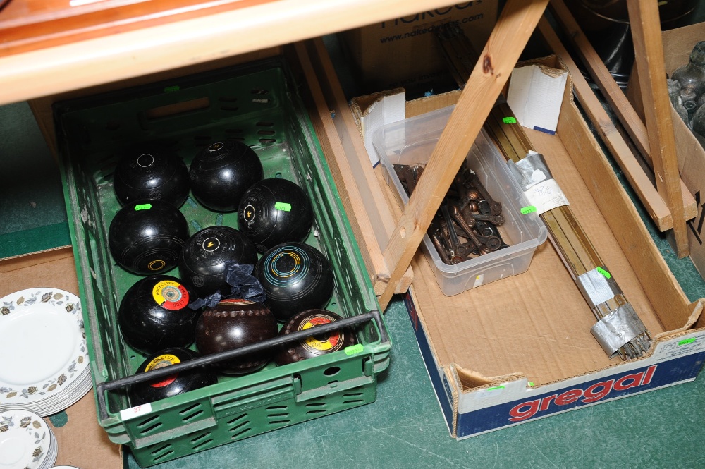 Two boxes inc. lawn bowls, brass stair rods etc.