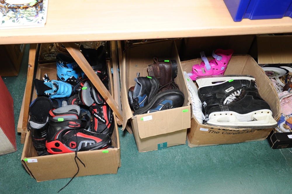Three boxes of boots, roller blades, ice skates etc.