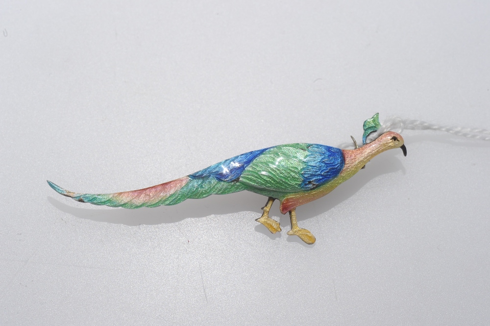 A vintage silver and enamel peacock brooch, decorated in brightly coloured shaded enamels. Length