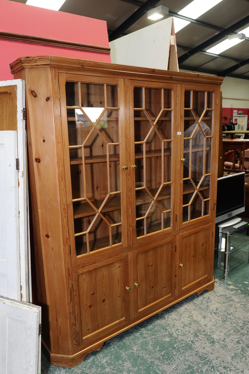 A pine glazed bookcase cabinet in period style