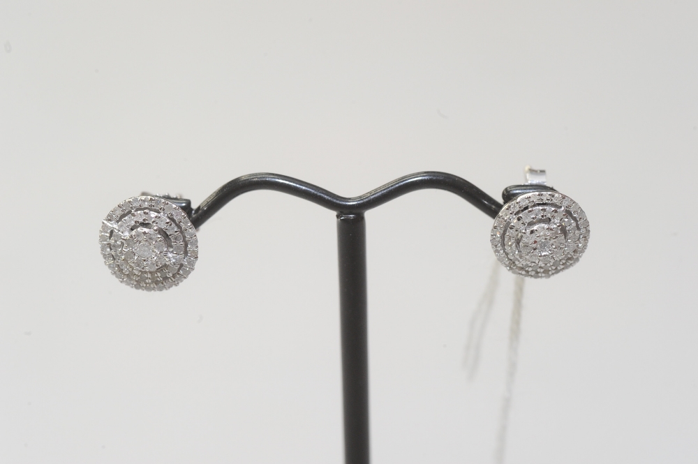A pair of diamond cluster earrings, mounted in 14ct white gold, post and butterfly fittings.