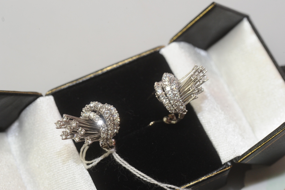 A pair of vintage diamond earrings, each with three graduated hoops issuing a spray, set