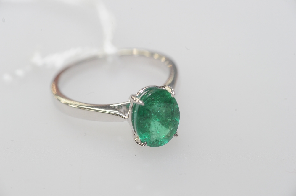 A single stone emerald ring, the oval-cut emerald claw-set on an 18ct white gold band. Emerald