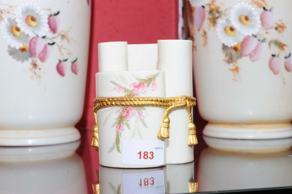 A Royal Worcester scroll shaped posy vase hand painted with pink flowers and foliage on a white